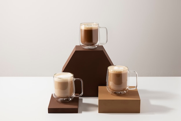 Free photo tasty coffee cups with foam assortment