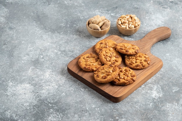 Free Photo tasty cookies with organic peanuts and honey on wooden board. 