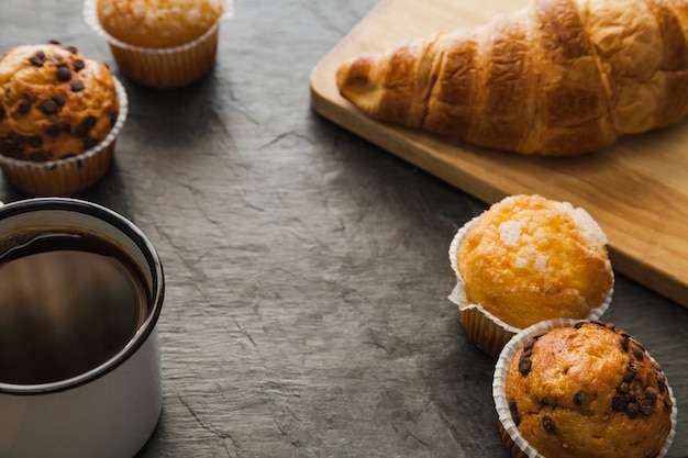 Tasty croissant and muffins with coffee