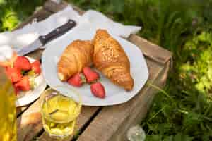 Free photo tasty croissants and strawberry high angle