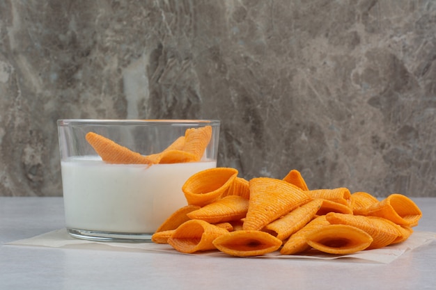 Free photo tasty crucnhy potato chips with sauce on white background. high quality photo