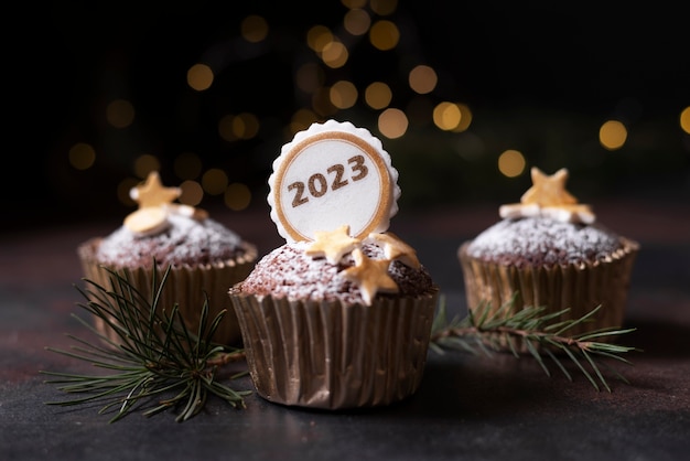 Tasty cupcakes and branches arrangement