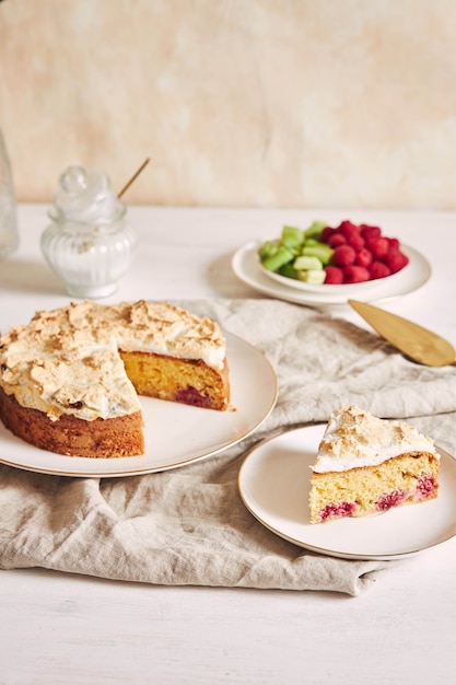 Tasty and delicious cake with baiser and  raspberries on a plate