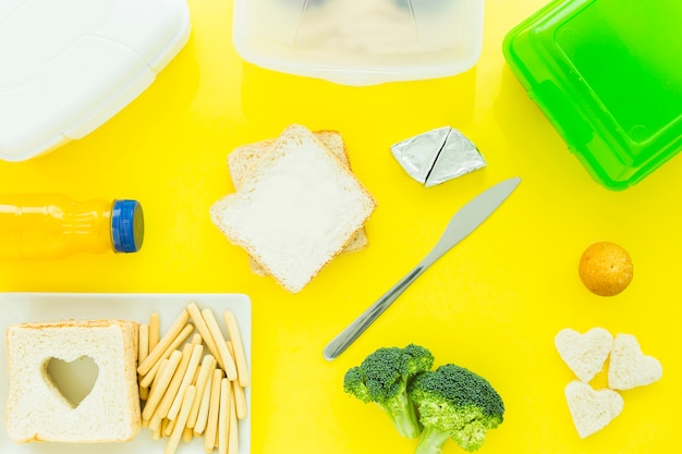 Tasty food and lunchboxes around toast