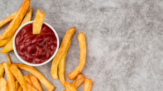 Free Photo tasty french fries spread on grey table