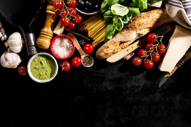 Free Photo tasty fresh appetizing italian food ingredients on dark background. ready to cook. home italian healthy food cooking concept. toning.