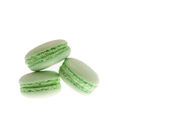 Tasty green macaroons isolated over white background. Delicious snack