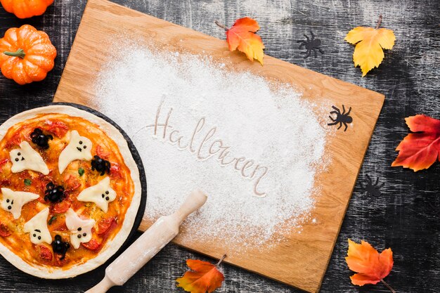 Tasty halloween pizza on wooden board