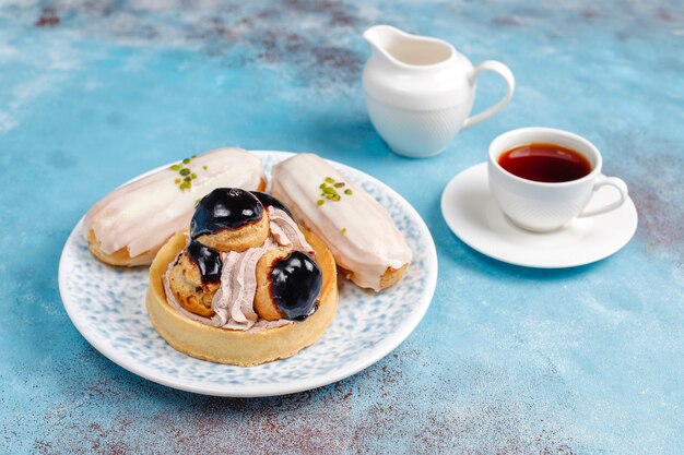 Tasty homemade pistachio eclairs with white chocolate.