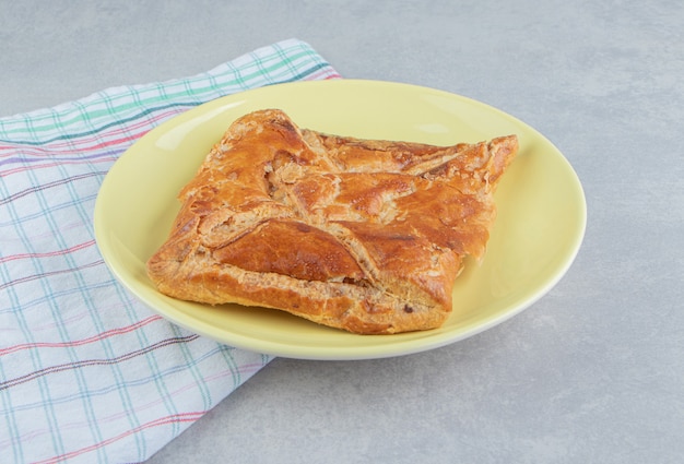 Tasty khachapuri pastry on yellow plate. 