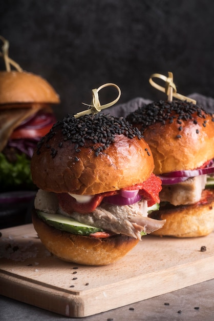 Tasty looking hamburgers on wooden board