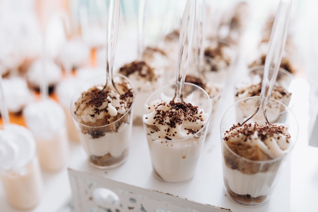 Tasty mousse dessert with whipped cream and chocolate at the banquet buffet table