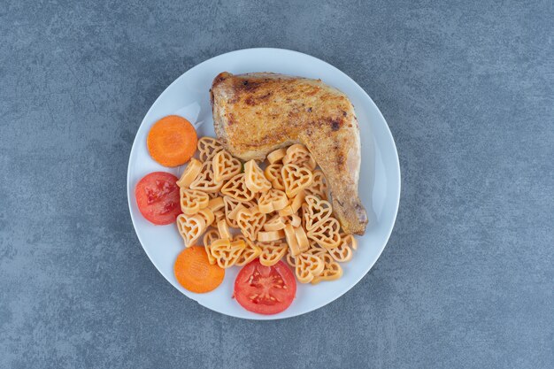 Tasty pasta with meat pieces on white plate.