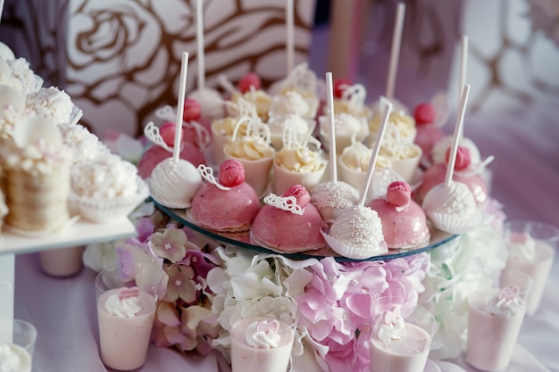 Tasty pink and white candies  served on plate