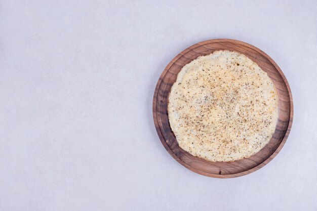 Tasty pizza on wooden plate