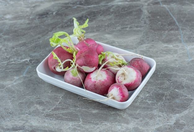 Free photo tasty radishes in the bowl , on the marble table.