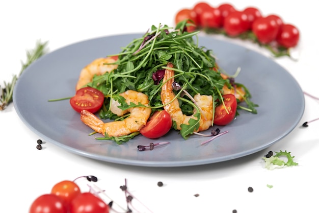 Free photo tasty salad with juicy shrimpstomatoes and fresh arugula