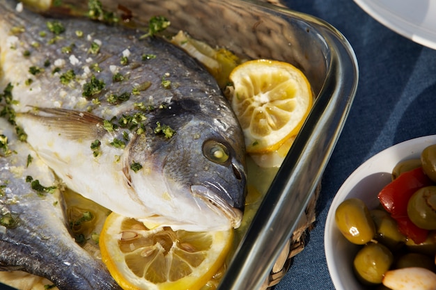 Tasty seabream with lemons high angle