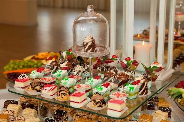 Tasty and sweet cakes on wedding banquet