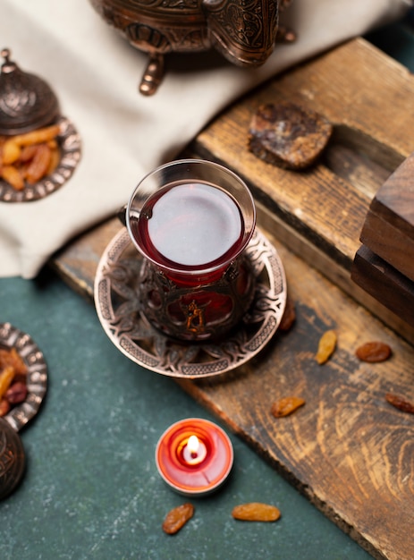 Tasty tea and snack with wooden background