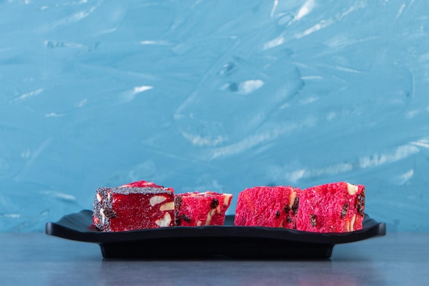 Tasty Turkish delights on a plate on the marble surface