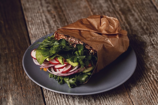 Tasty vegan sandwich over wooden table