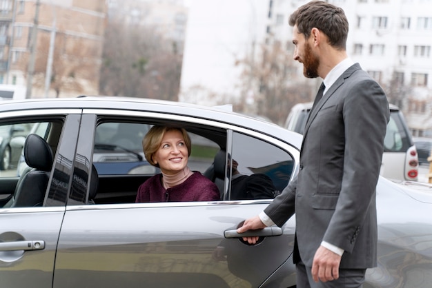 Taxi driver and female client interacting in a formal way