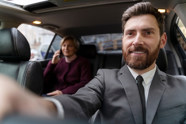 Free Photo taxi driver and female client interacting in a formal way