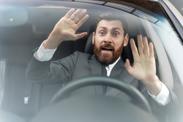 Free photo taxi driver looking scared before an accident