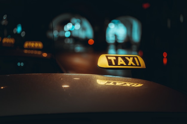 Free photo taxi sign at night.