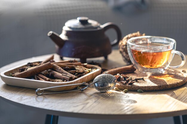 Free Photo tea ceremony glass cup of black tea and teapot different types of spices