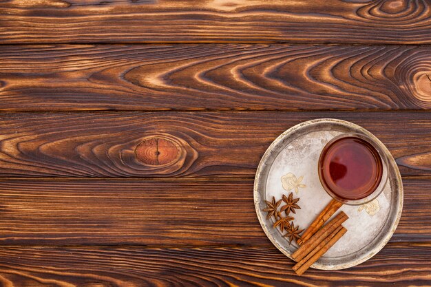 Tea cup with cinnamon and anise on plate