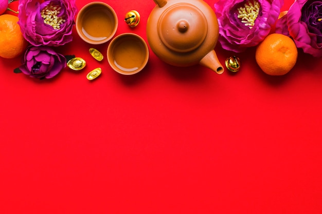 Free Photo tea set amidst flowers and tangerines