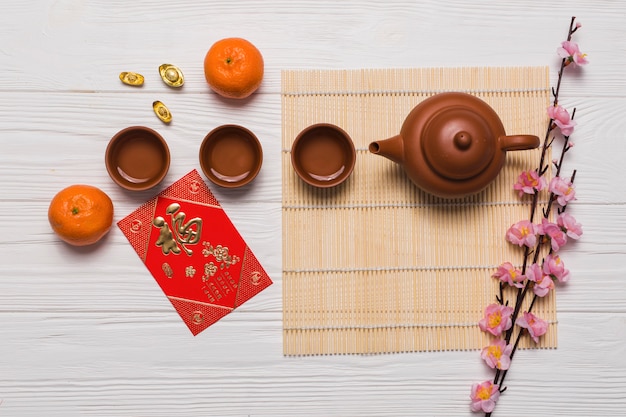 Tea set near card and flowers