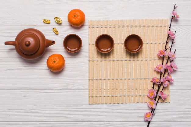 Free photo tea set and sakura branch