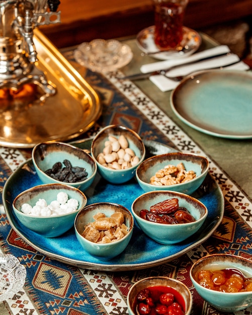 Tea set with dried fruits nuts and jams