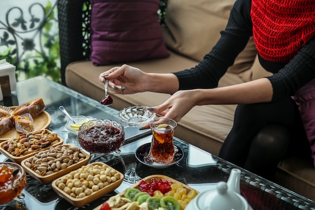 Free photo tea set with sweets, lemon and jams