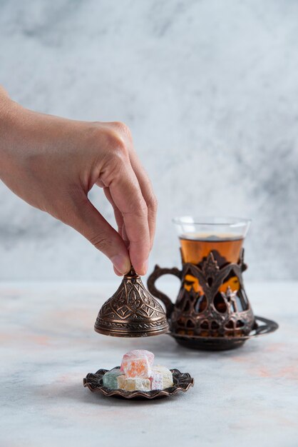 Tea Table. Man opening candy crockery beside of tea