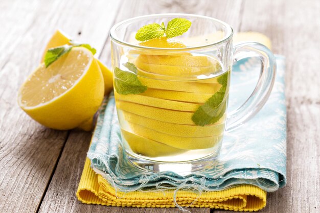 Tea with mint and whole lemon in a transparent cup