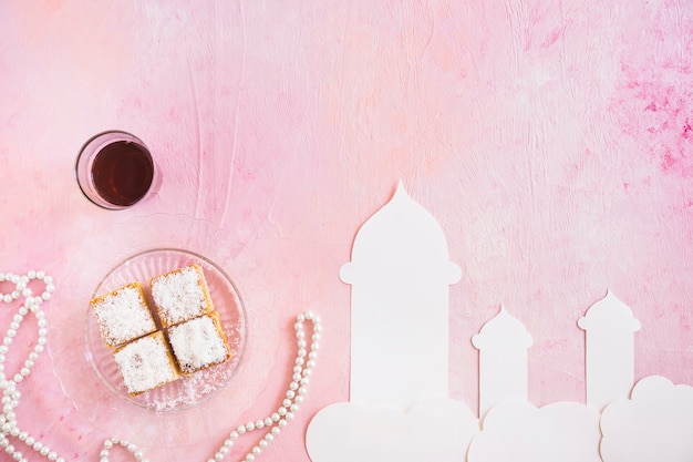 Free Photo tea with sweets and mosque cut out