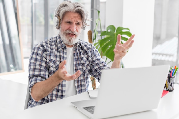 Teacher at desk talking to laptop