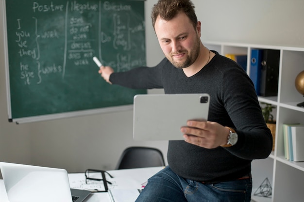 Teacher doing an english lesson online for his students