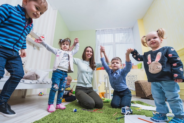 Teacher and kids playing in classroom