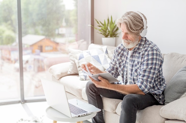 Teacher looking at notebook near laptop