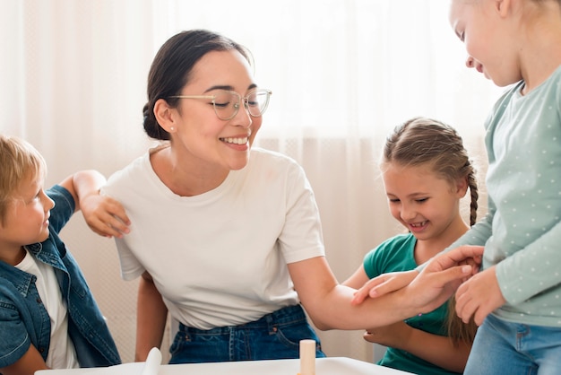 Teacher playing with children indoors