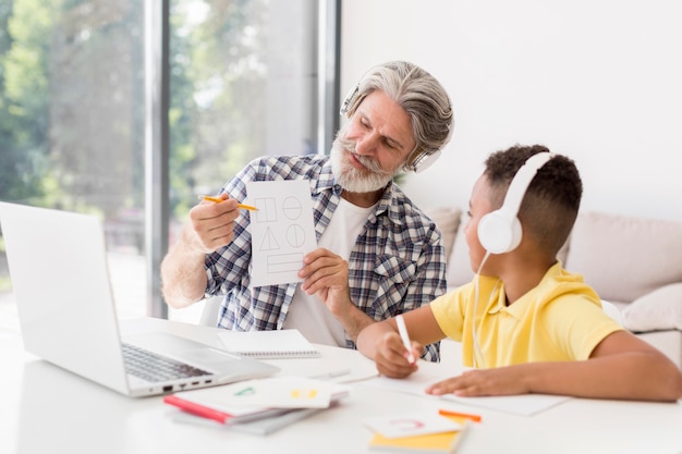 Teacher showing geometric shapes to student