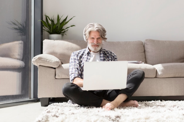 Teacher staying on ground using laptop