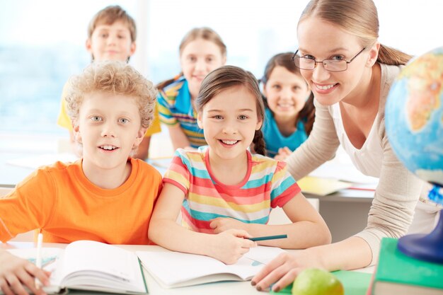 Teacher and students smiling in class