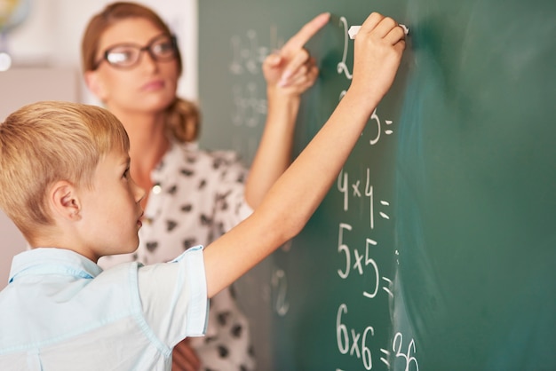 Teacher trying to help boy understand the Maths