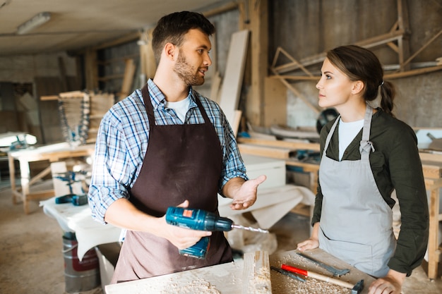 Free photo teaching apprentice to use electric drill